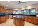 Open kitchen featuring wood cabinetry, black countertops and tile backsplash at 1234 E Claire Dr, Phoenix, AZ 85022