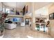 Open-concept living room with balcony, piano, and view to dining area at 1234 E Claire Dr, Phoenix, AZ 85022