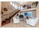 Spacious living room featuring a grand staircase, a piano, and plenty of natural light at 1234 E Claire Dr, Phoenix, AZ 85022