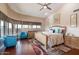 Bright main bedroom features many windows for natural light, ceiling fan, and wood flooring at 1234 E Claire Dr, Phoenix, AZ 85022