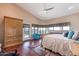 Spacious main bedroom featuring a ceiling fan, many windows, and an exterior door at 1234 E Claire Dr, Phoenix, AZ 85022