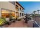 Charming outdoor patio with brick flooring, a tiered fountain, and views of lush greenery at 1234 E Claire Dr, Phoenix, AZ 85022