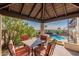 Spacious covered patio with dining furniture, views of the pool, and landscaped backyard for outdoor entertaining at 1234 E Claire Dr, Phoenix, AZ 85022