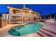 Back of a two-story home with a pool and large patio with outdoor seating at 1234 E Claire Dr, Phoenix, AZ 85022