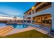 Inviting backyard oasis featuring a sparkling pool, lush landscaping, and a covered patio perfect for entertaining at 1234 E Claire Dr, Phoenix, AZ 85022