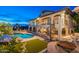 Exterior of a two-story home with a pool, a spiral staircase, and an outdoor fireplace at 1234 E Claire Dr, Phoenix, AZ 85022