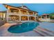 Gorgeous backyard featuring a pool, covered patio, manicured lawn, and a two-story home at 1234 E Claire Dr, Phoenix, AZ 85022