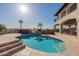 Refreshing swimming pool with a charming umbrella, alongside a well-maintained home with balconies at 1234 E Claire Dr, Phoenix, AZ 85022