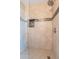 Tiled shower with a glass door, built in toiletry cubby, and rainfall shower head at 1234 E Claire Dr, Phoenix, AZ 85022