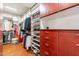 Organized walk-in closet with custom shelves and hanging rods for optimal storage at 1234 E Claire Dr, Phoenix, AZ 85022