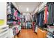Spacious walk-in closet with custom shelving, hanging rods, and organized storage for clothes and accessories at 1234 E Claire Dr, Phoenix, AZ 85022