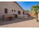 Relaxing backyard with a hot tub, brick patio, palm tree, and outdoor seating at 13155 W Monterey Way, Litchfield Park, AZ 85340
