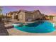 Inviting backyard with a sparkling pool and spa, complemented by a spacious patio area at 13155 W Monterey Way, Litchfield Park, AZ 85340