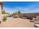 Spacious backyard with brick pavers, pool, string lights, and outdoor dining area at 13155 W Monterey Way, Litchfield Park, AZ 85340