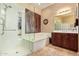 Well-lit bathroom with a shower, tub, and a spacious vanity, offering a relaxing atmosphere at 13155 W Monterey Way, Litchfield Park, AZ 85340