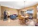 Open floor plan with dining table and living room, showcasing room to entertain guests at 13155 W Monterey Way, Litchfield Park, AZ 85340
