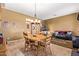 Open concept living and dining area featuring tile floors, natural light, and access to common areas at 13155 W Monterey Way, Litchfield Park, AZ 85340