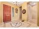 A welcoming foyer features decorative tile flooring and an elegant chandelier lighting at 13155 W Monterey Way, Litchfield Park, AZ 85340