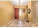 A welcoming foyer features decorative tile flooring and an elegant chandelier lighting at 13155 W Monterey Way, Litchfield Park, AZ 85340