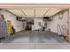 Spacious two car garage with overhead storage, shelving, water heater, and epoxy flooring at 13155 W Monterey Way, Litchfield Park, AZ 85340