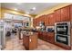 Modern kitchen with stainless steel appliances, custom cabinetry, and center island at 13155 W Monterey Way, Litchfield Park, AZ 85340