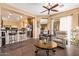 Open concept living room showcases a coffee bar, tiled floors, and stainless steel appliances at 13155 W Monterey Way, Litchfield Park, AZ 85340