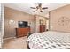 Bright main bedroom boasts wood furniture, a TV, and ample natural light at 13155 W Monterey Way, Litchfield Park, AZ 85340