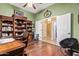 Comfortable office space featuring wood floors, custom shelves and nearby bathroom access at 13155 W Monterey Way, Litchfield Park, AZ 85340