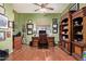 Inviting home office with custom wood desk, built-in shelving, and ample natural light, creating a perfect workspace at 13155 W Monterey Way, Litchfield Park, AZ 85340