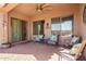 Inviting outdoor patio featuring comfortable seating and a ceiling fan for relaxed entertaining at 13155 W Monterey Way, Litchfield Park, AZ 85340