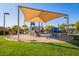 Community playground with shade structure, slide, and climbing features in a well-maintained area at 13155 W Monterey Way, Litchfield Park, AZ 85340