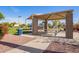 Community playground featuring a picnic table under a shaded awning at 13155 W Monterey Way, Litchfield Park, AZ 85340