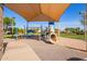 Community playground featuring a shaded playground with slides and climbing equipment at 13155 W Monterey Way, Litchfield Park, AZ 85340