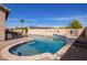 Private pool with blue tile and stone surround in a sunny backyard setting at 13155 W Monterey Way, Litchfield Park, AZ 85340