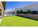 Secluded backyard featuring artificial grass, a safety fence, and lush landscaping at 1341 E Paseo Way, Phoenix, AZ 85042