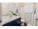 Charming bathroom with a blue vanity, white countertop, and a neatly arranged shower with modern fixtures at 1341 E Paseo Way, Phoenix, AZ 85042