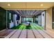 Entertain on this covered patio complete with a stone fireplace, tv, and sliding glass doors at 1341 E Paseo Way, Phoenix, AZ 85042