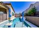 The backyard oasis features a sparkling pool with an umbrella and beautiful tile accents at 1341 E Paseo Way, Phoenix, AZ 85042