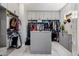 Well-organized walk-in closet featuring custom shelving, ample hanging space, and a center island for accessories at 1341 E Paseo Way, Phoenix, AZ 85042