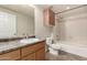 Bathroom featuring a vanity sink, storage cabinet, and a shower-tub combo with tile surround at 14250 W Wigwam Blvd # 2111, Litchfield Park, AZ 85340