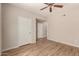 Bright bedroom featuring wood-look flooring, a ceiling fan, and a neutral color palette at 14250 W Wigwam Blvd # 2111, Litchfield Park, AZ 85340