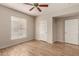 Comfortable bedroom with wood-look floors, ample natural light, and closet space at 14250 W Wigwam Blvd # 2111, Litchfield Park, AZ 85340