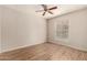 Well-lit bedroom with a large window offering natural light and wood-look flooring at 14250 W Wigwam Blvd # 2111, Litchfield Park, AZ 85340