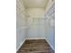 Walk-in closet with built-in metal shelving and wood-look flooring at 14250 W Wigwam Blvd # 2111, Litchfield Park, AZ 85340