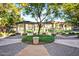 Lush community courtyard featuring mature shade trees and decorative pergola in a park-like setting at 14250 W Wigwam Blvd # 2111, Litchfield Park, AZ 85340