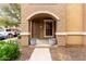 Inviting condo entrance with a covered porch and lovely potted plants at 14250 W Wigwam Blvd # 2111, Litchfield Park, AZ 85340