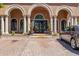 Elegant entrance to villa complex, with stately columns and ample parking at 14250 W Wigwam Blvd # 2111, Litchfield Park, AZ 85340