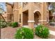 Charming condo exterior featuring a covered entry and well-maintained landscaping at 14250 W Wigwam Blvd # 2111, Litchfield Park, AZ 85340