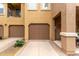 Home exterior showing two-car garage and tidy landscaping at 14250 W Wigwam Blvd # 2111, Litchfield Park, AZ 85340