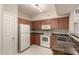 Efficient kitchen with white appliances, wood cabinets, and ample counter space at 14250 W Wigwam Blvd # 2111, Litchfield Park, AZ 85340
